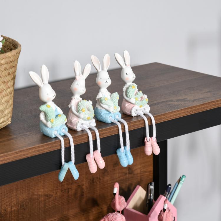 Walnut top shelf of a 4-tier bookshelf with bunny figurines and stationery