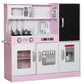 Pink kids play kitchen with stovetop, sink faucet, and large black chalkboard area