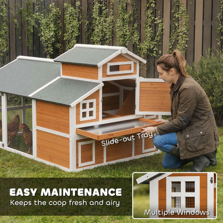 Wooden chicken coop with slide-out tray at front and fenced run side panel