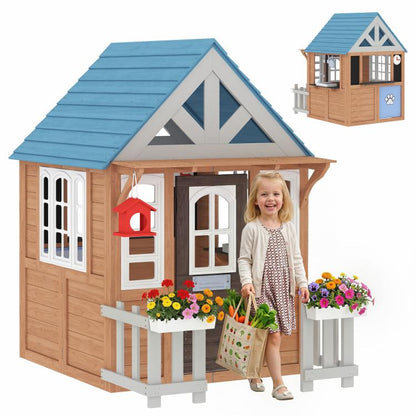 Wooden kids playhouse with blue roof, white doors, windows, fence, and flower boxes