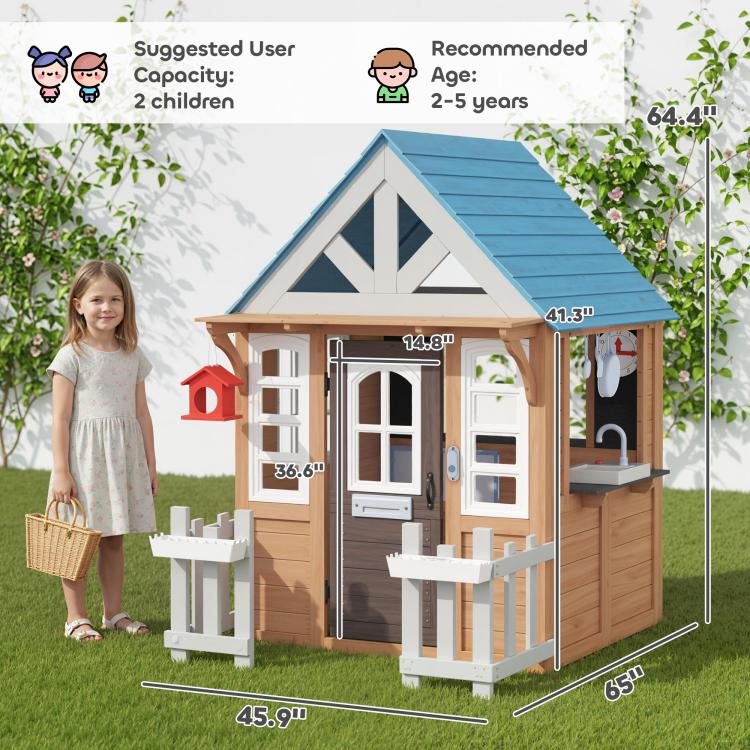 Wooden kids playhouse with blue roof, white doors and windows, fence, and play accessories