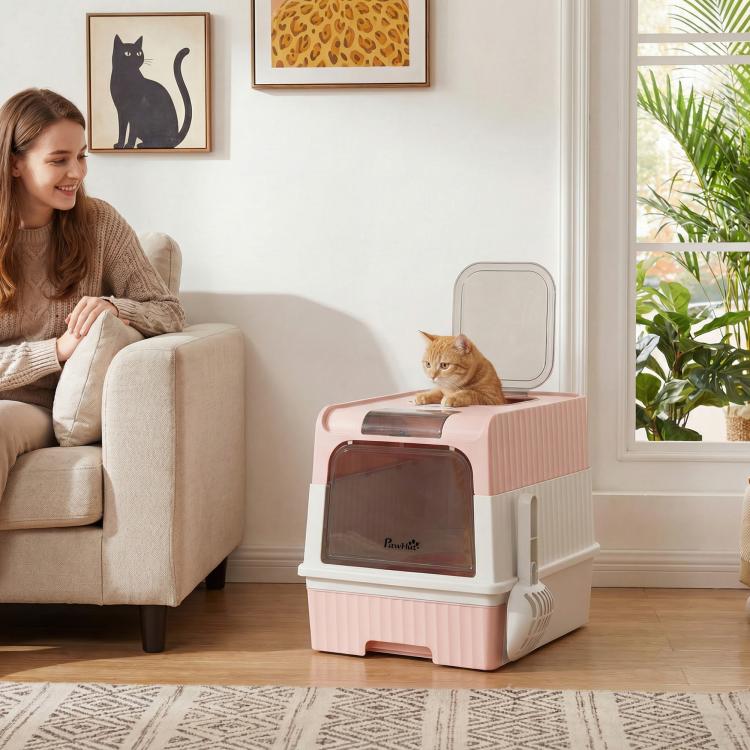 Pink hooded cat litter box with front entry and top exit window, shown on floor