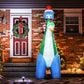 LED-lit inflatable dinosaur yard decoration with Christmas tree in mouth