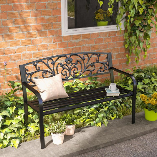 Black metal 2-seat garden bench with ornate scrollwork back and beige seat cushion