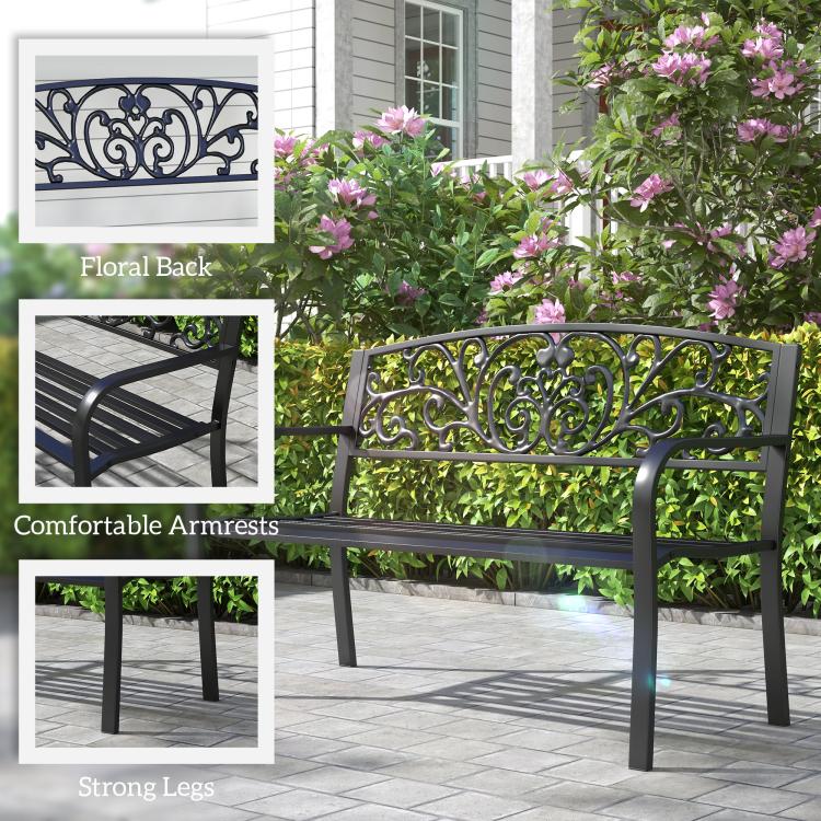 Black metal garden bench with floral scroll back panel, curved armrests, slatted seat
