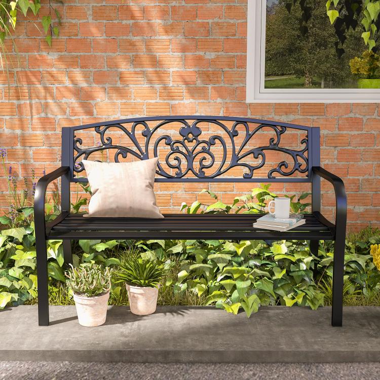 Black metal 2-seat bench with ornate scrollwork back and beige seat cushion