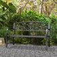 Black metal garden bench with ornate scrollwork backrest and slatted seat, armrests
