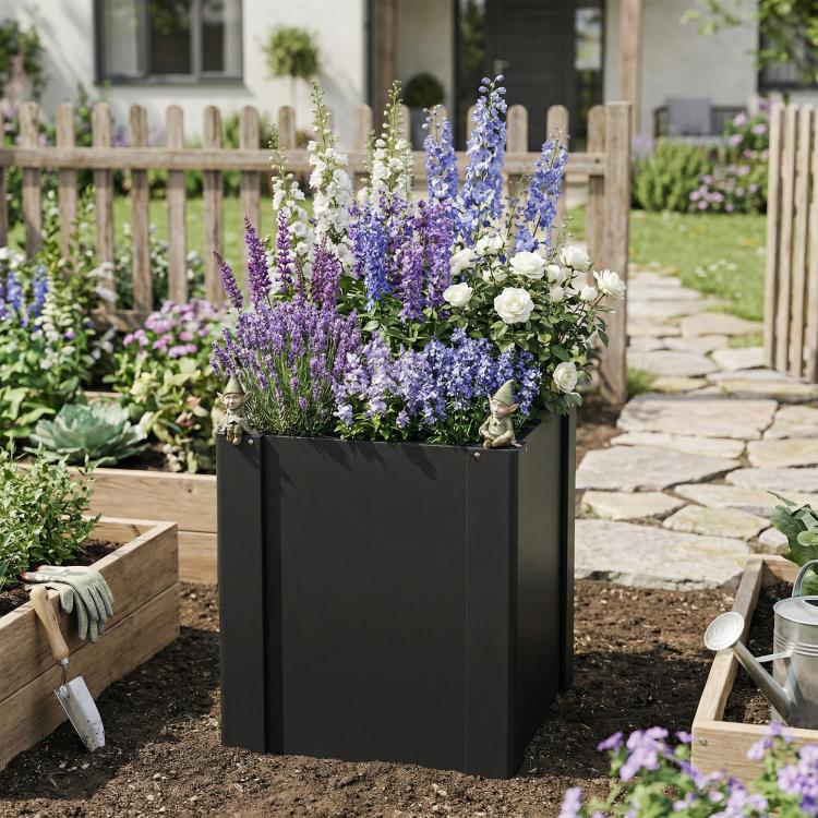 Black raised garden bed planter box filled with purple and white flowers