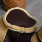 Light brown plush ride-on horse toy with dark brown saddle and foot area