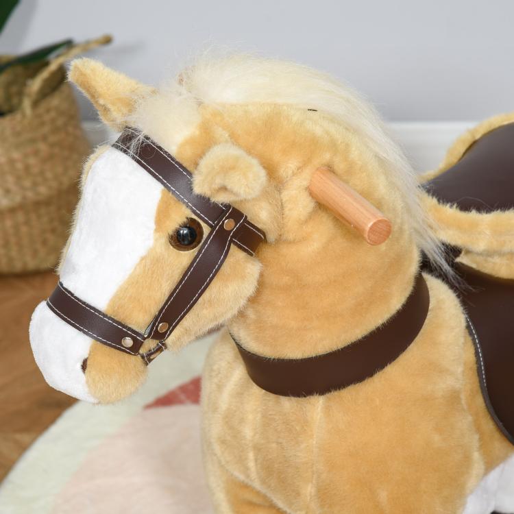 Light brown plush horse head with dark bridle and wooden handle, close-up
