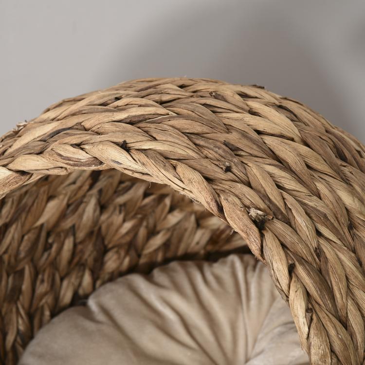 Close-up of light brown rattan wicker weave on the cat bed rim