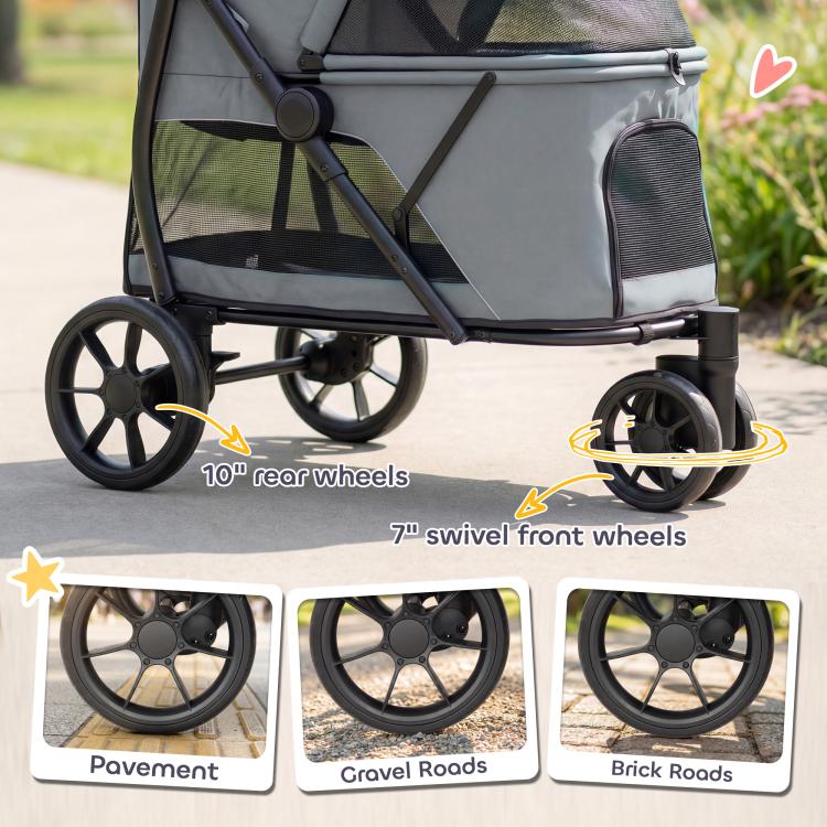 Gray pet stroller detail view of swivel front wheels and large rear wheels