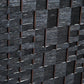 Close-up of black hand-woven lattice diamond pattern on folding room divider