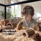 Clear acrylic hamster cage with bedding, wood hides, and small hamster inside