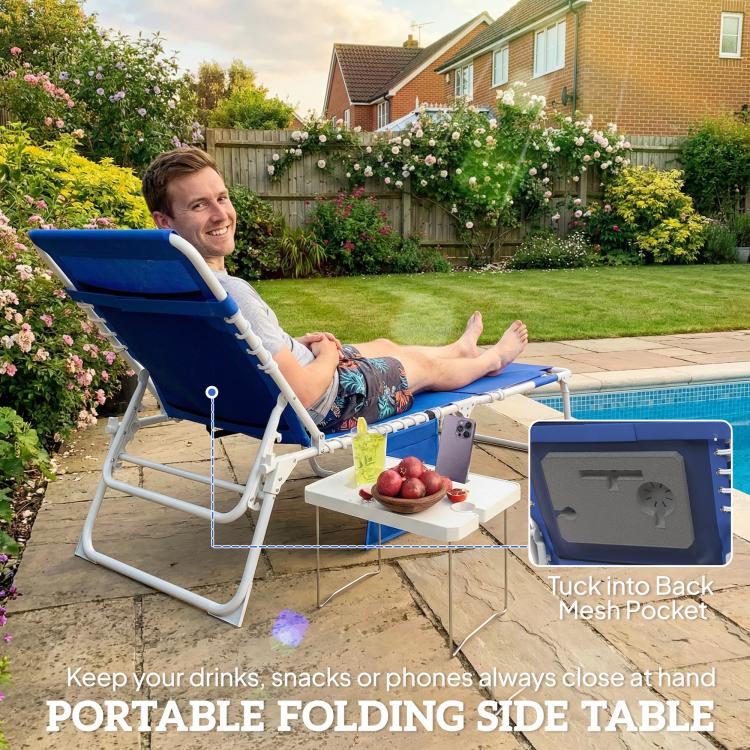 Blue folding tanning lounge with side table and face hole in backyard setting