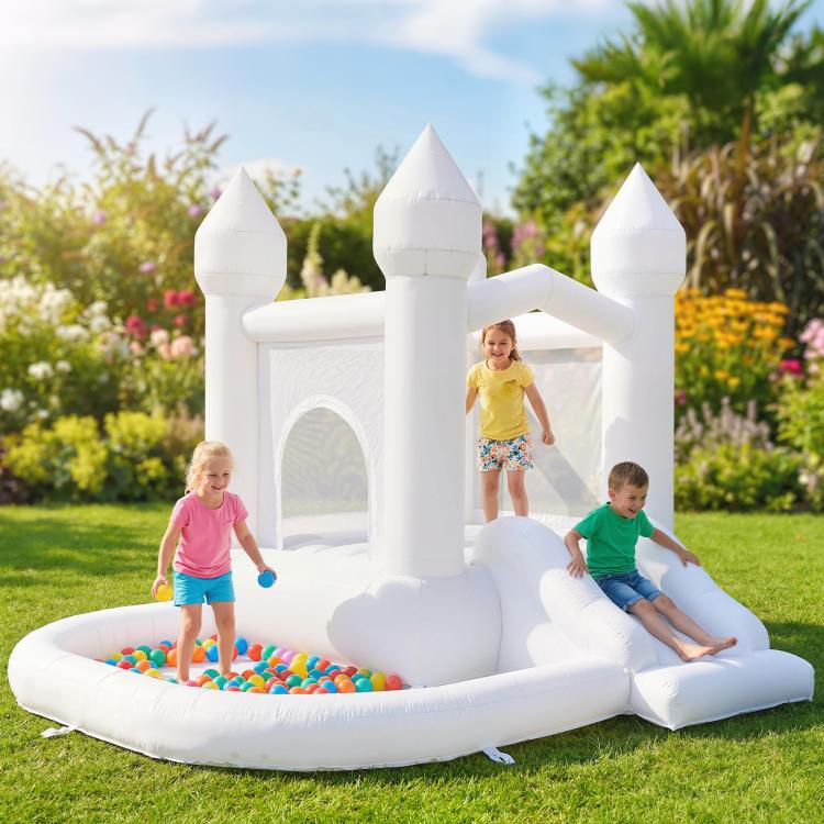 Outdoor white inflatable castle bounce house with slide, ball pit, and kids playing