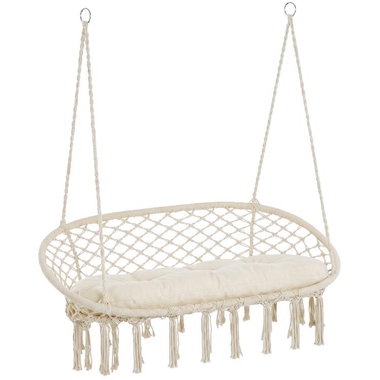 White hanging macrame hammock chair with round seat, cushion, and cotton fringe