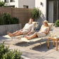 Two beige tanning chaise lounges with face pillows, reclining on an outdoor patio