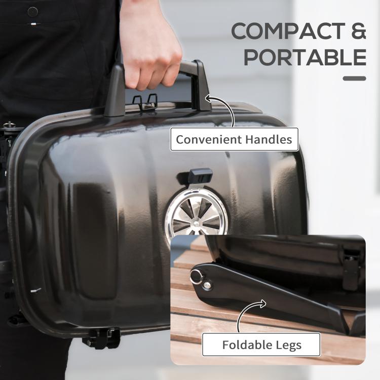 Compact portable black charcoal grill with convenient carry handles and foldable legs