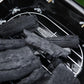 Close-up of charcoal bed inside a portable black charcoal grill cooking chamber