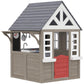 Gray wooden kids playhouse with white trim, red door, and multi-pane windows