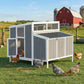 Large gray wooden chicken coop with side doors, mesh window, and slatted roof