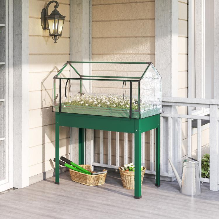 Green raised bed with clear greenhouse cover on legs for outdoor patio gardening