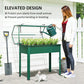 Green elevated garden bed with clear flip-up greenhouse cover and plant watering
