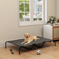 Gray elevated dog bed with black metal legs and mesh top on hardwood floor