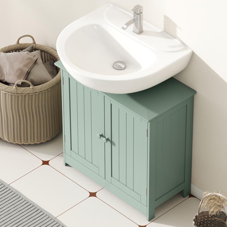 Green bathroom vanity cabinet with two doors, round knobs, and a white sink on top