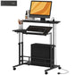 Black adjustable standing desk with tiltable work surface, keyboard tray, storage shelf, wheels.