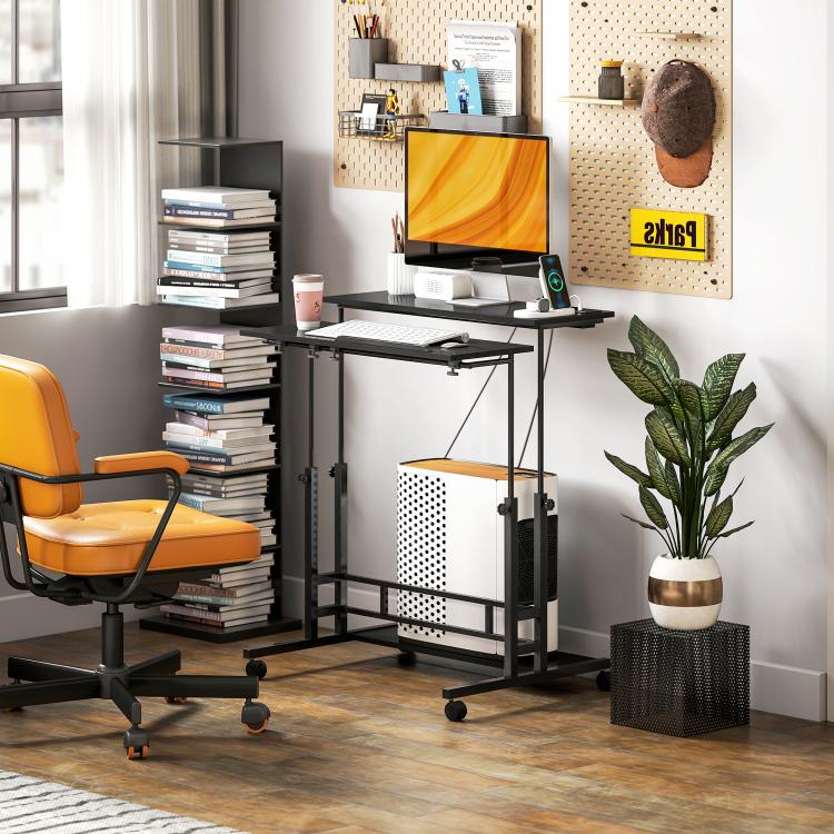 Black rolling standing desk with monitor stand, tilting keyboard tray, and bottom storage cabinet.
