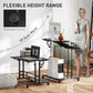 Black standing desk with height adjustment knobs, tilting tabletop, keyboard tray, wheels.