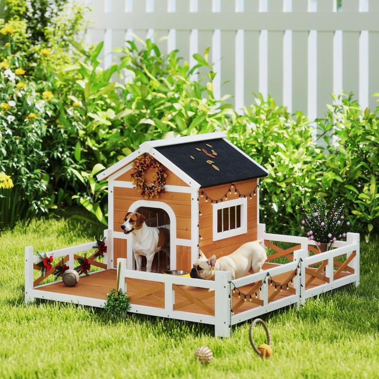 Wooden dog house with arched doorway, fenced porch, and black shingled roof