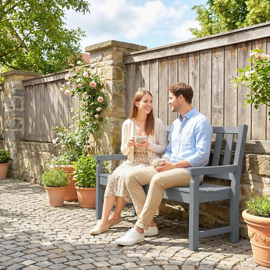 Gray 2-person garden bench with curved seat for outdoor seating