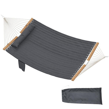 Gray outdoor hammock with pillow and padded surface, rope suspension and wooden spreader bars