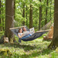 Gray camping hammock with pillow support, hanging ropes and wooden spreader bars