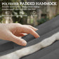 Gray padded hammock fabric with soft texture, close-up hand resting on surface