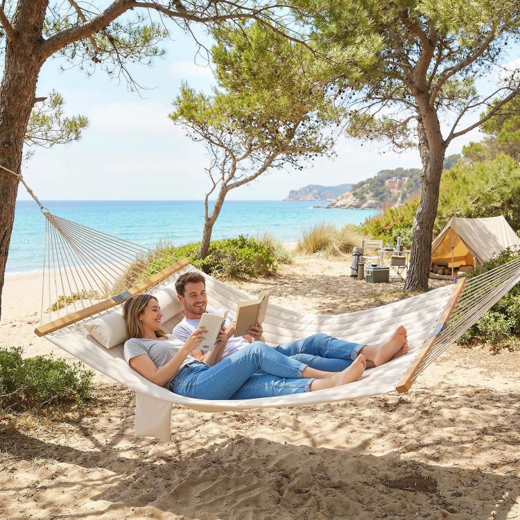 Cream two-person hammock with pillow for relaxing outdoors near the beach