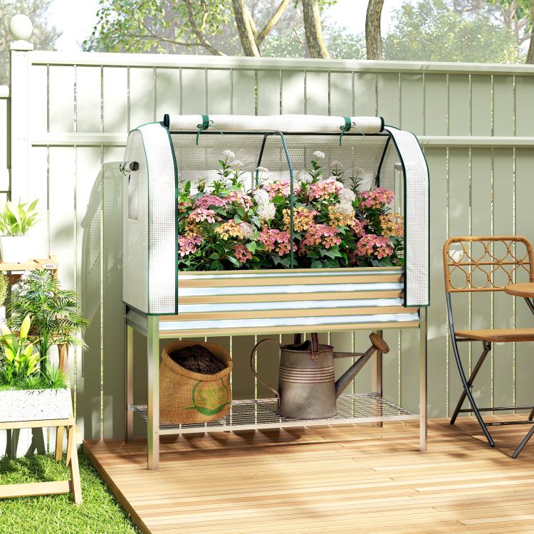 Silver raised garden bed with green greenhouse cover and lower storage shelf