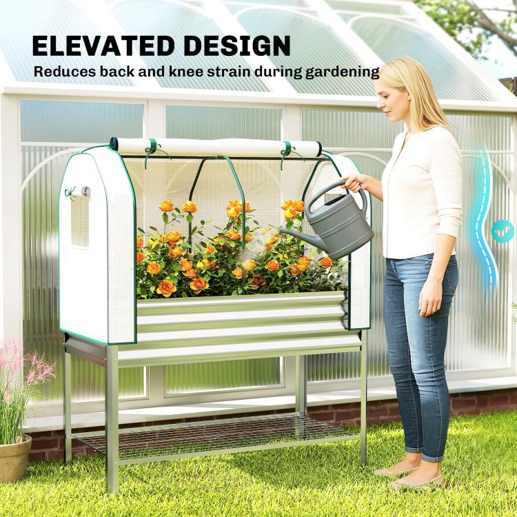 Elevated raised garden bed with green greenhouse cover and front access panel
