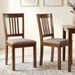 Walnut upholstered dining chairs with slatted back and padded light gray seat cushions