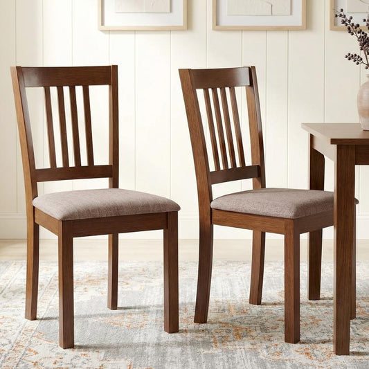 Walnut upholstered dining chairs with slatted back and padded light gray seat cushions