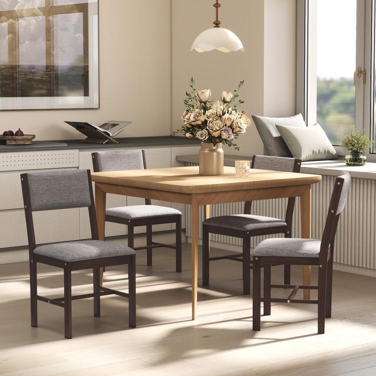 Dining chairs with gray upholstered seats and dark wood frames around wooden table