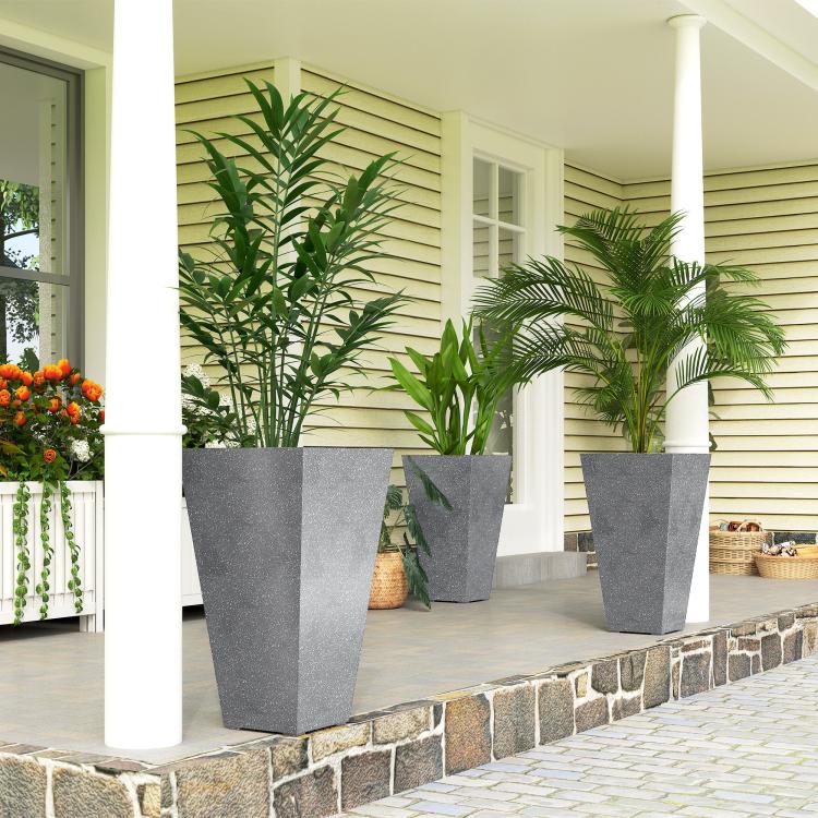 Set of 3 tall gray tapered plastic planters with plants on outdoor step edge