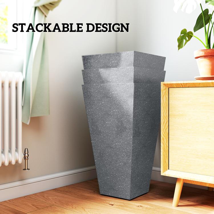 Stackable tall gray tapered plastic planters nested together with plants