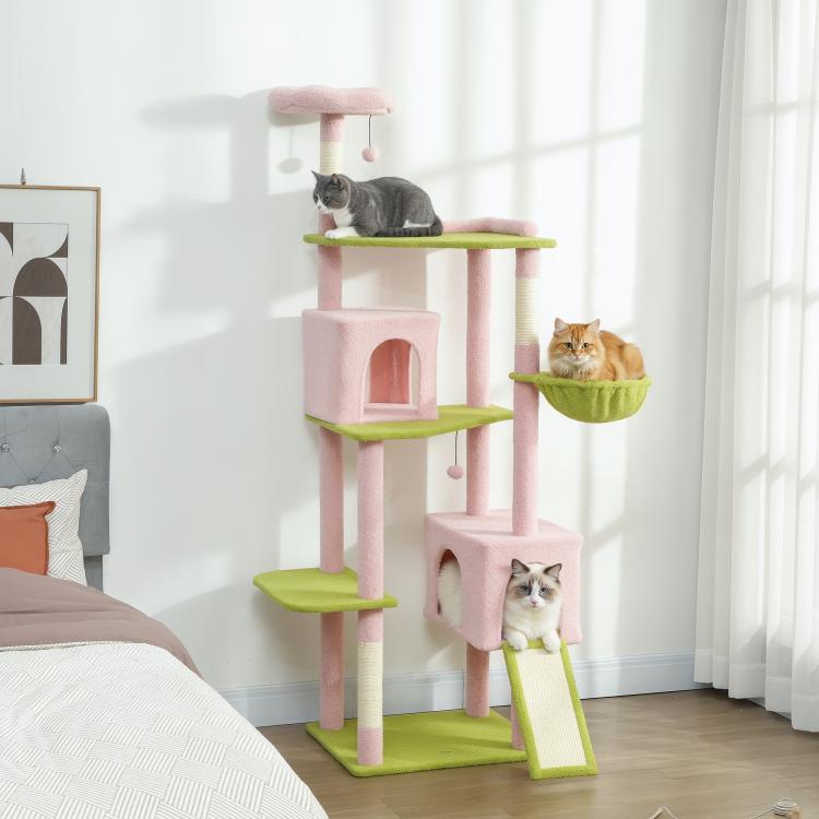 Indoor pink cat tree with green perches, two condos, and three levels