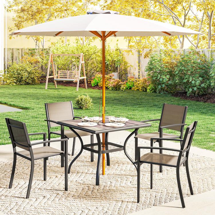 Square patio dining table with gray top and umbrella pole, surrounded by outdoor chairs