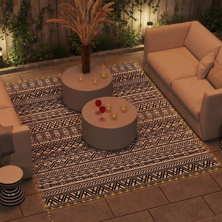 Outdoor rug carpet with black-and-white geometric pattern and bordered edges