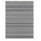 Reversible patio rug with black-and-white geometric stripes and fringe edges